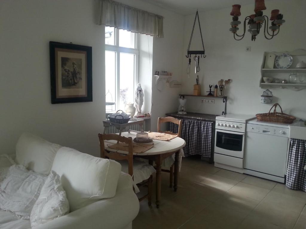 a living room with a table and a kitchen at Das Rosenhaus in Lieser