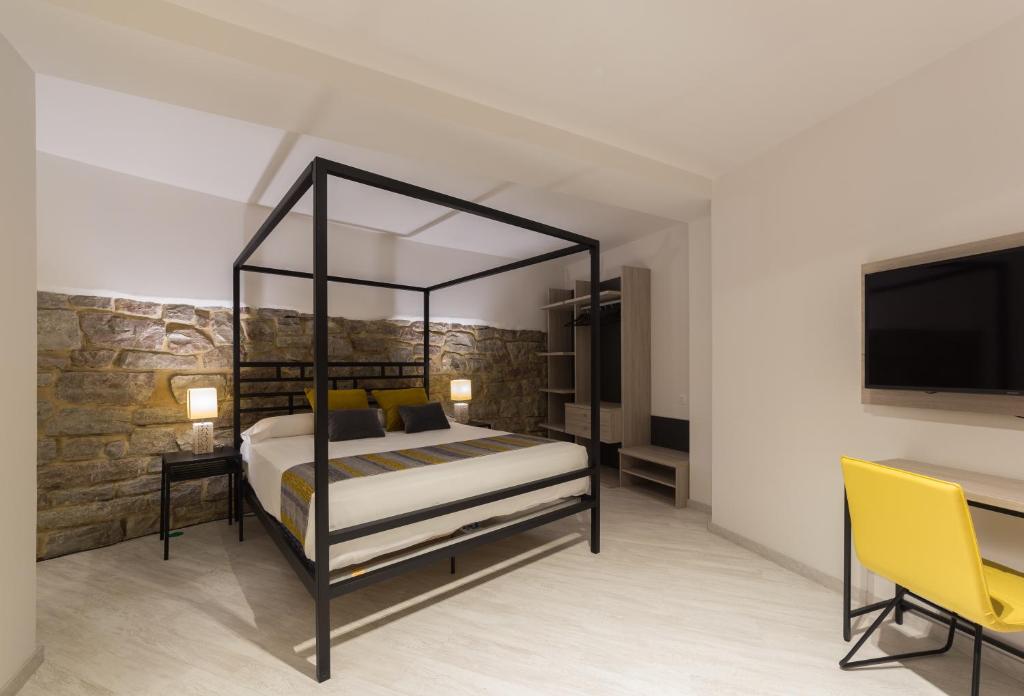 Postel nebo postele na pokoji v ubytování Hotel Onyarbi