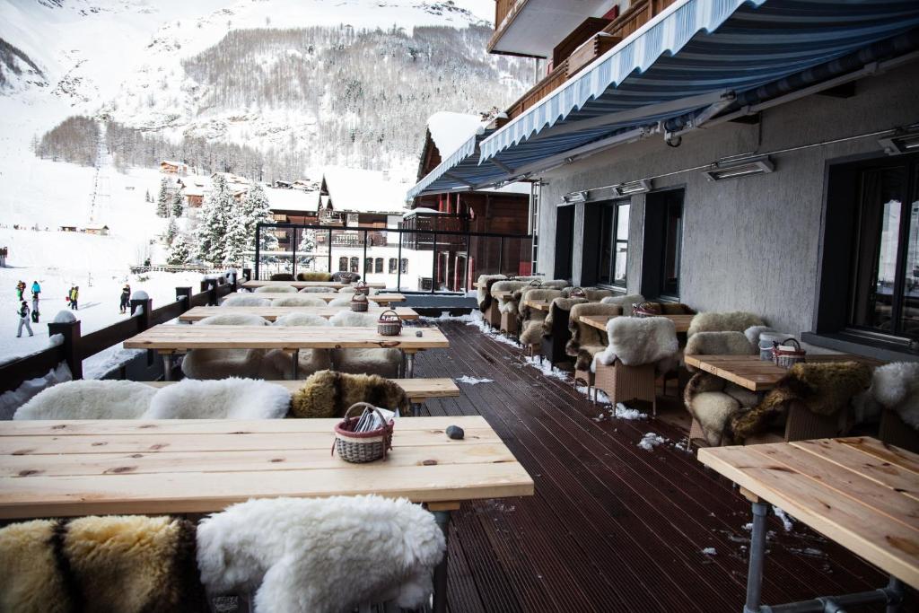 a row of tables with sheep on a building at Hotel THE LARIX ski-in ski-out in Saas-Fee