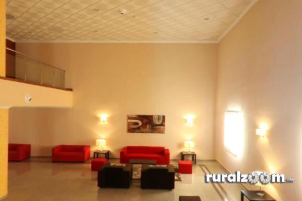 a living room with red couches in a room at Hotel Romero Merida in Mérida