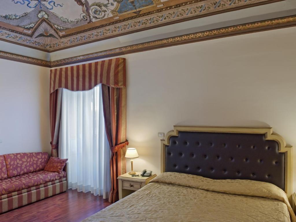 A bed or beds in a room at Hotel Manganelli Palace