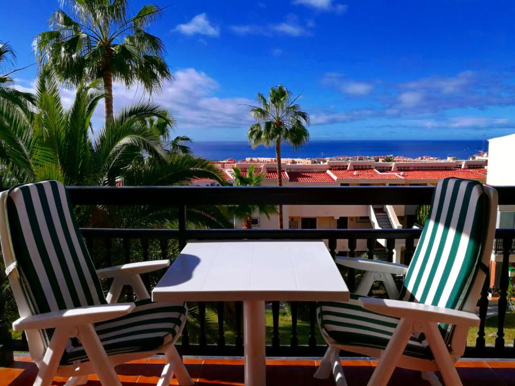 a table and chairs on a balcony with a view of the ocean at Miraverde Bright studio with Great Views in Adeje