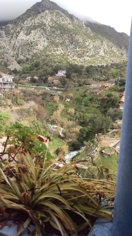 a view of a hill with a mountain in the background at Hostal La Joya in Chefchaouene