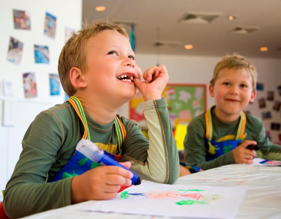 two young boys sitting at a table in a classroom at Anassa in Polis Chrysochous
