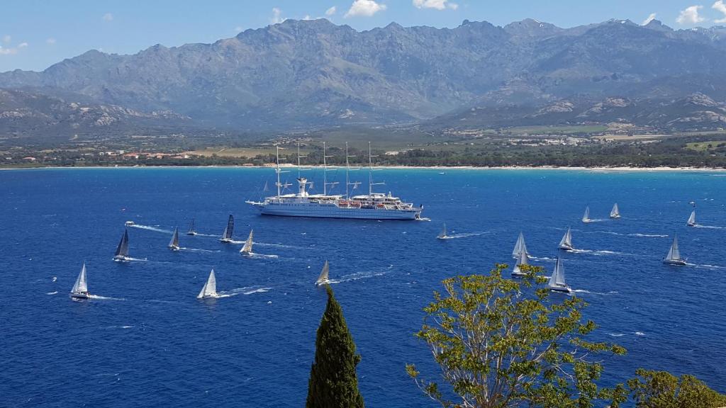 a large boat in a large body of water with sailboats at Casa ANNA in Calvi
