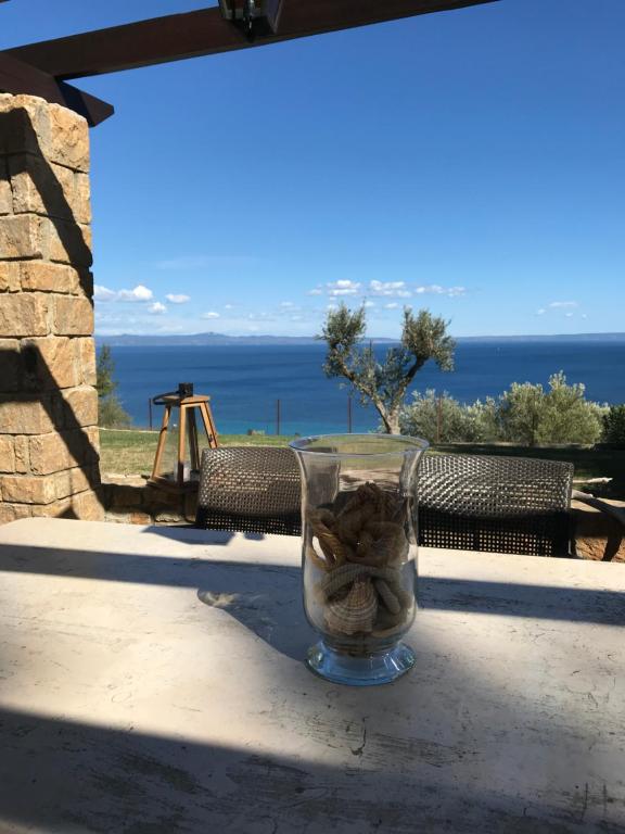 a glass vase filled with rocks sitting on a table at The House of Blue in Afitos