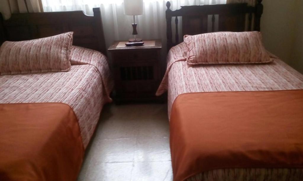 Postel nebo postele na pokoji v ubytování GHL casa hotel