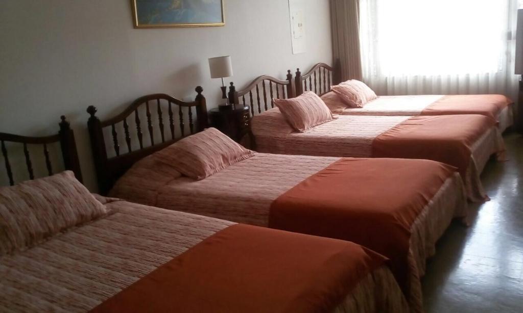 Postel nebo postele na pokoji v ubytování GHL casa hotel