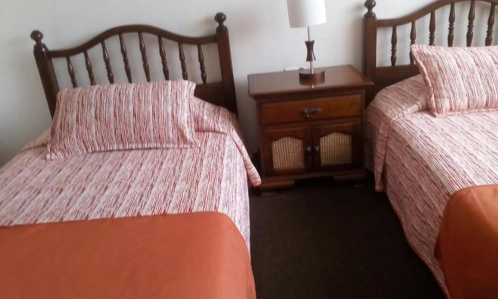 Postel nebo postele na pokoji v ubytování GHL casa hotel