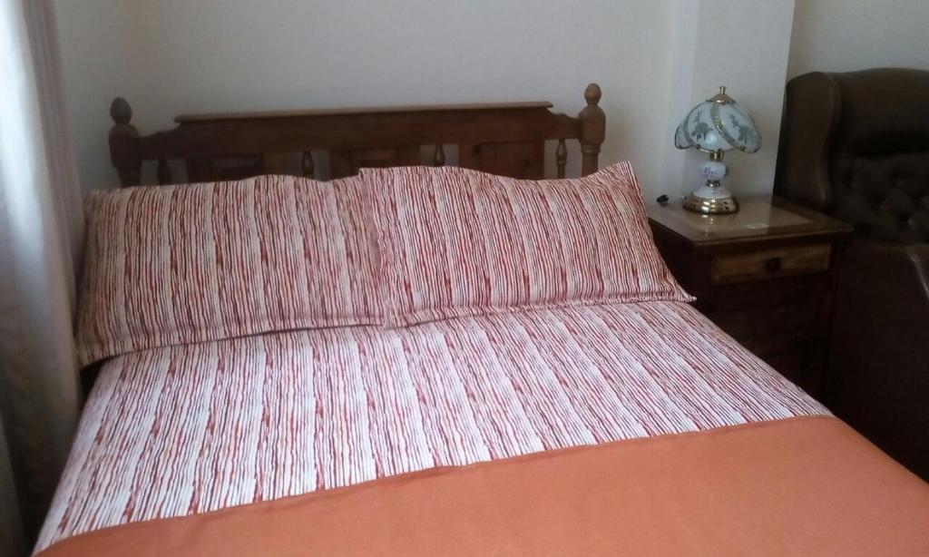 Postel nebo postele na pokoji v ubytování GHL casa hotel