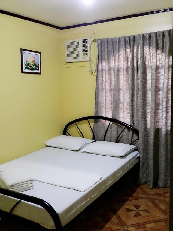 Postel nebo postele na pokoji v ubytování Carribean Transient House