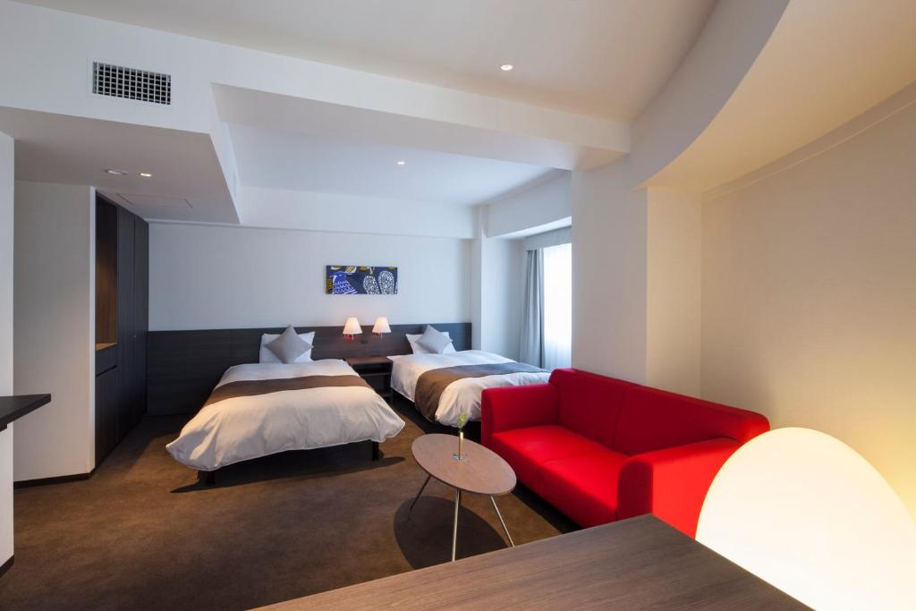 Postel nebo postele na pokoji v ubytování Ginza Grand Hotel