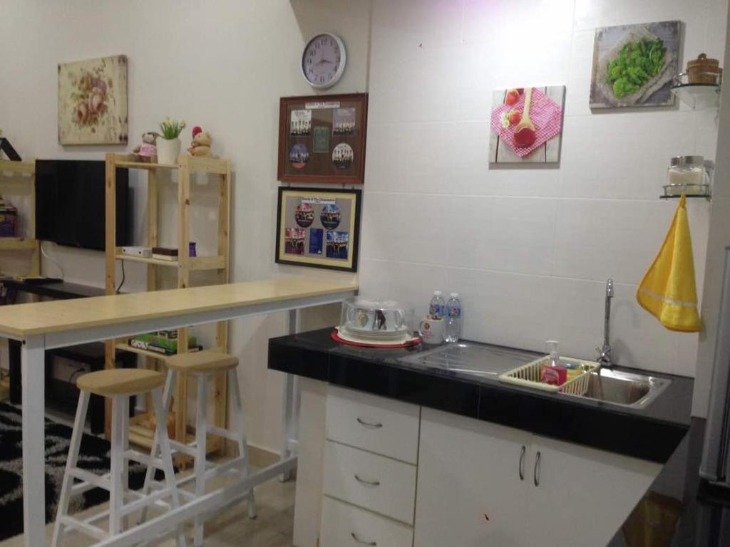 a kitchen with a counter top and a sink at Julia's Cottage in Kota Bharu