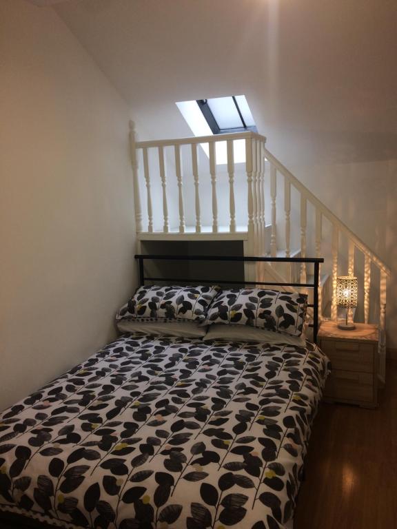 a bedroom with a bed with a window at Eastgate Apartment in Inverness