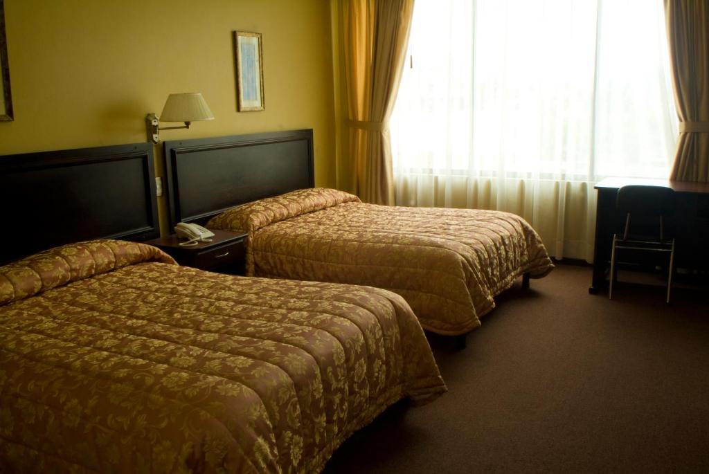 Postel nebo postele na pokoji v ubytování Hotel Podocarpus