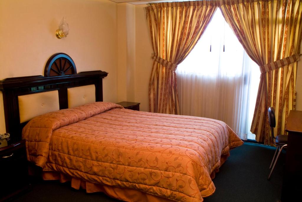 Postel nebo postele na pokoji v ubytování Hotel Podocarpus