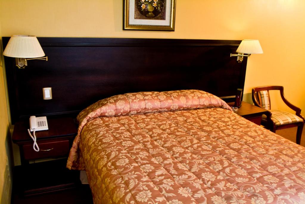 Postel nebo postele na pokoji v ubytování Hotel Podocarpus