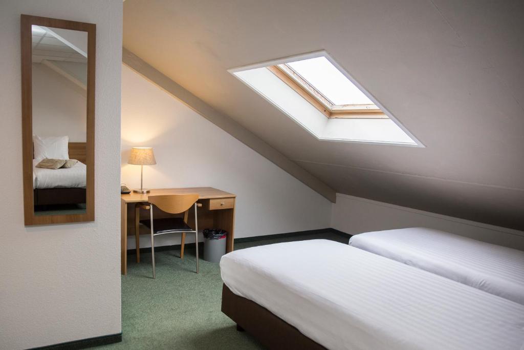 Postel nebo postele na pokoji v ubytování Fletcher Hotel Restaurant Heidehof