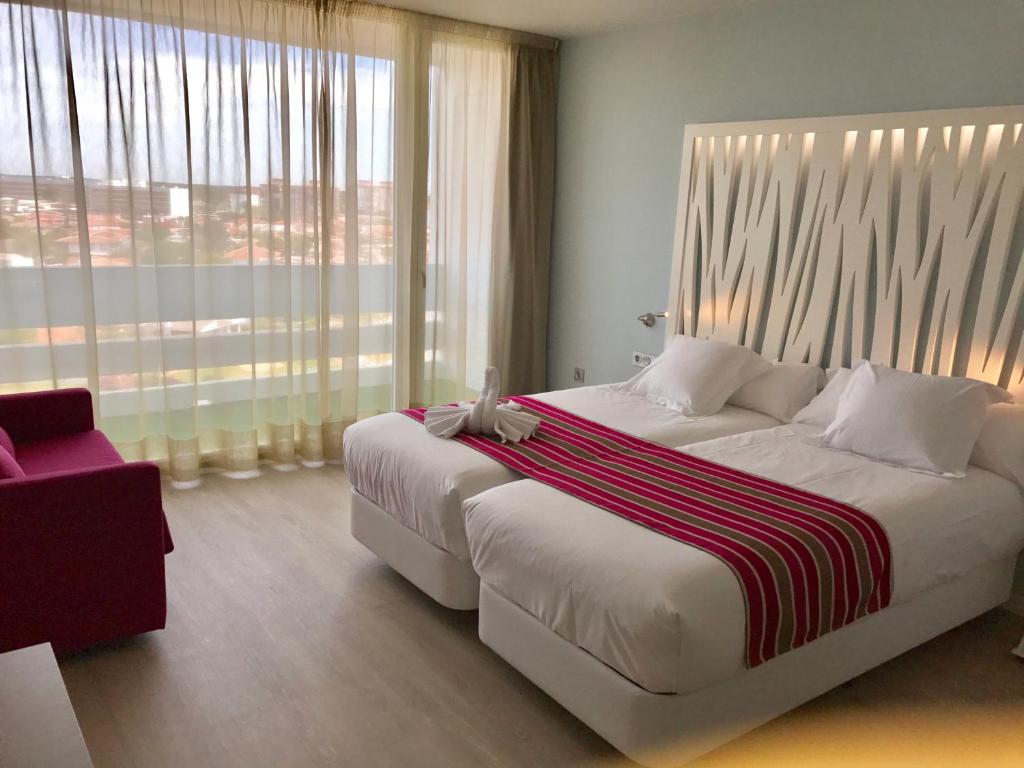 Postel nebo postele na pokoji v ubytování Hotel Flamero