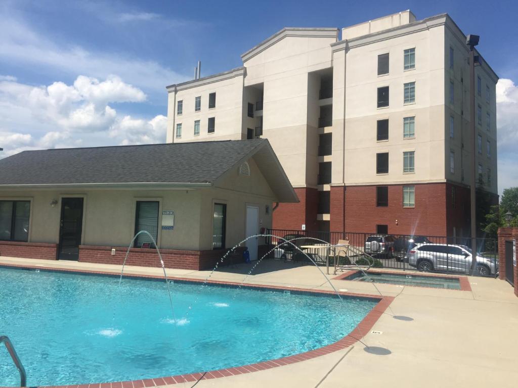 a swimming pool with water fountains in front of a building at River Crossing Resort in Pigeon Forge