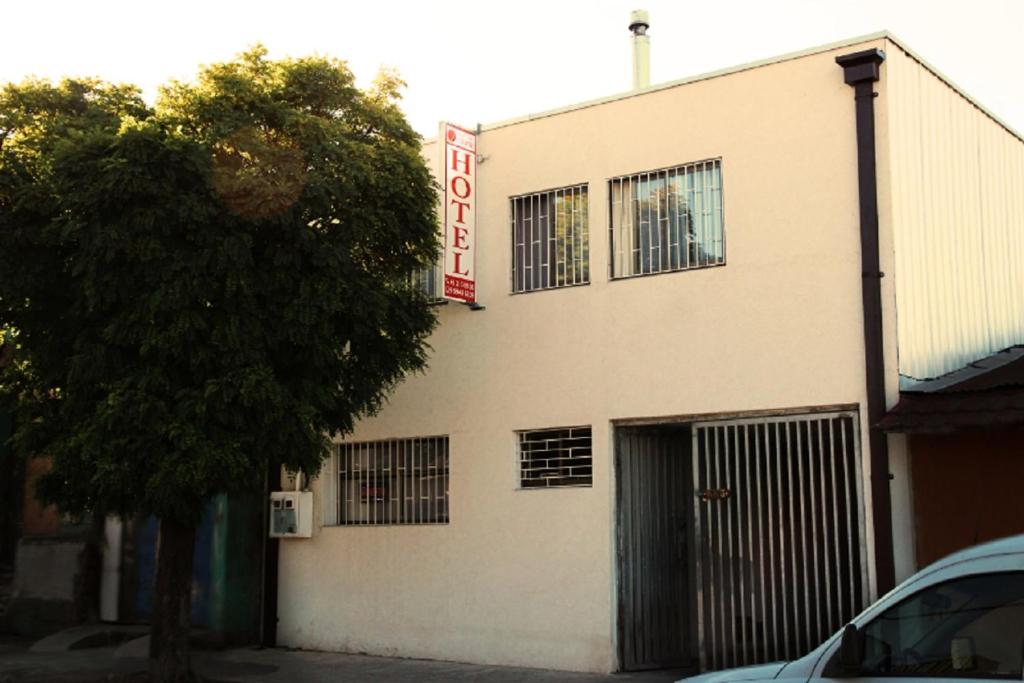 a white building with a sign on the side of it at Hotel Eclipse in Concepción