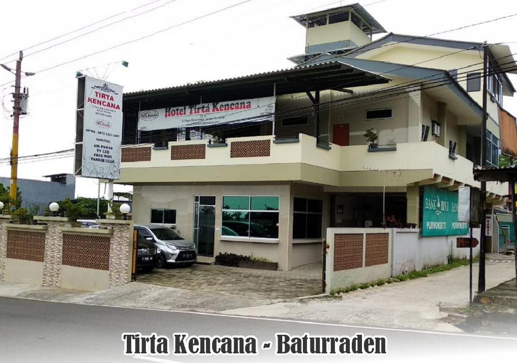 a building with a car parked in front of it at Tirta Kencana Baturraden in Baturaden