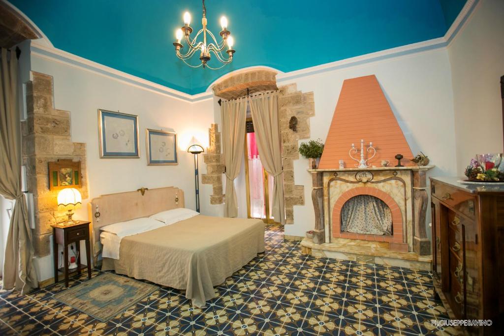 a bedroom with a bed and a fireplace at B&B Savarini in Palo del Colle