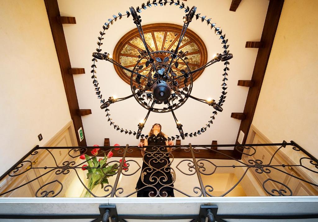 a large chandelier hanging from a stairway at Algilà Ortigia Charme Hotel in Siracusa