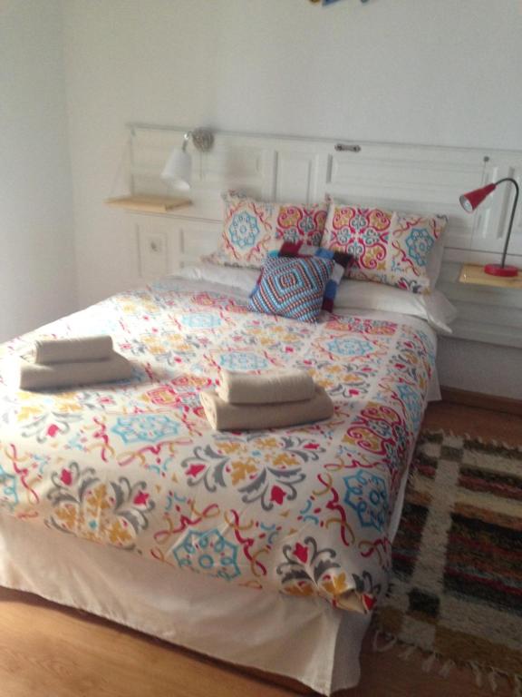 Un dormitorio con una cama grande con almohadas. en El Taller del Abuelo, en Córdoba