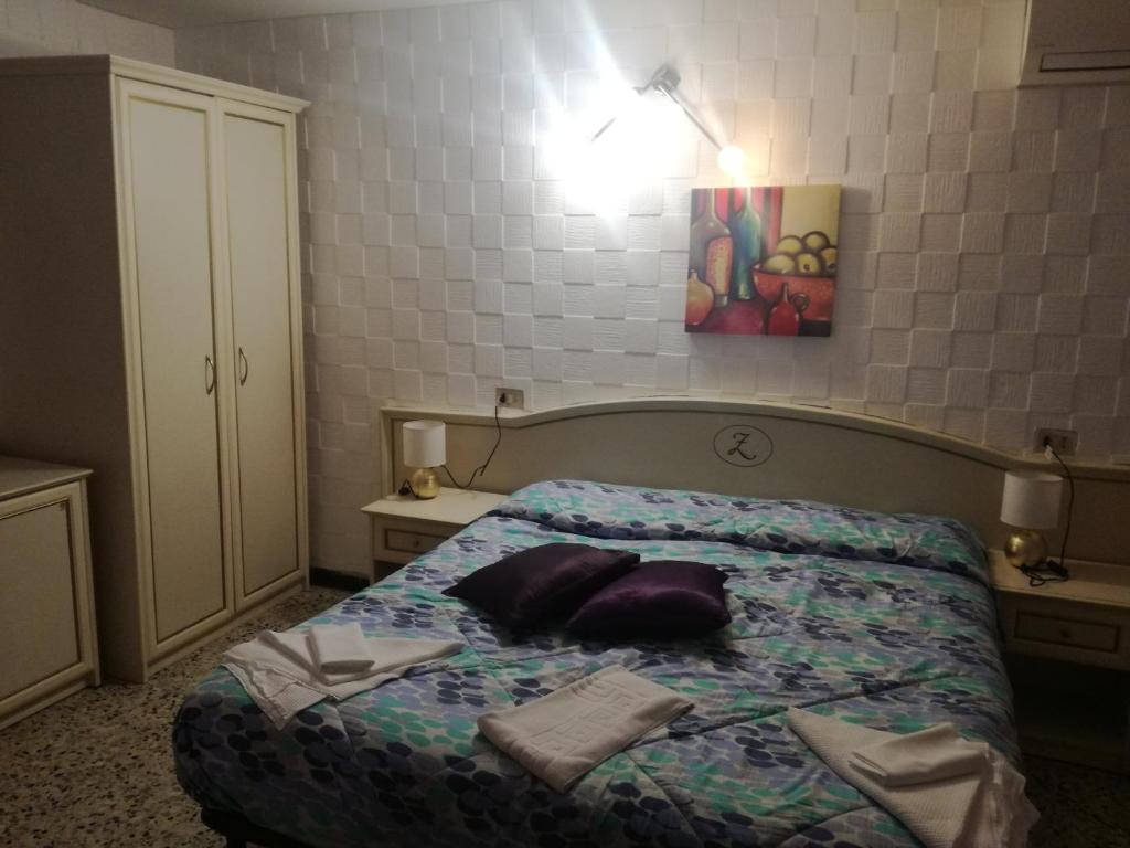 Postel nebo postele na pokoji v ubytování Hotel La Zorza