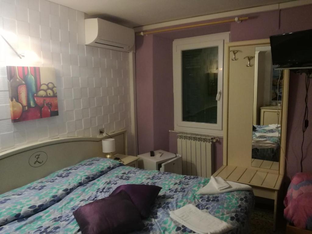 Postel nebo postele na pokoji v ubytování Hotel La Zorza