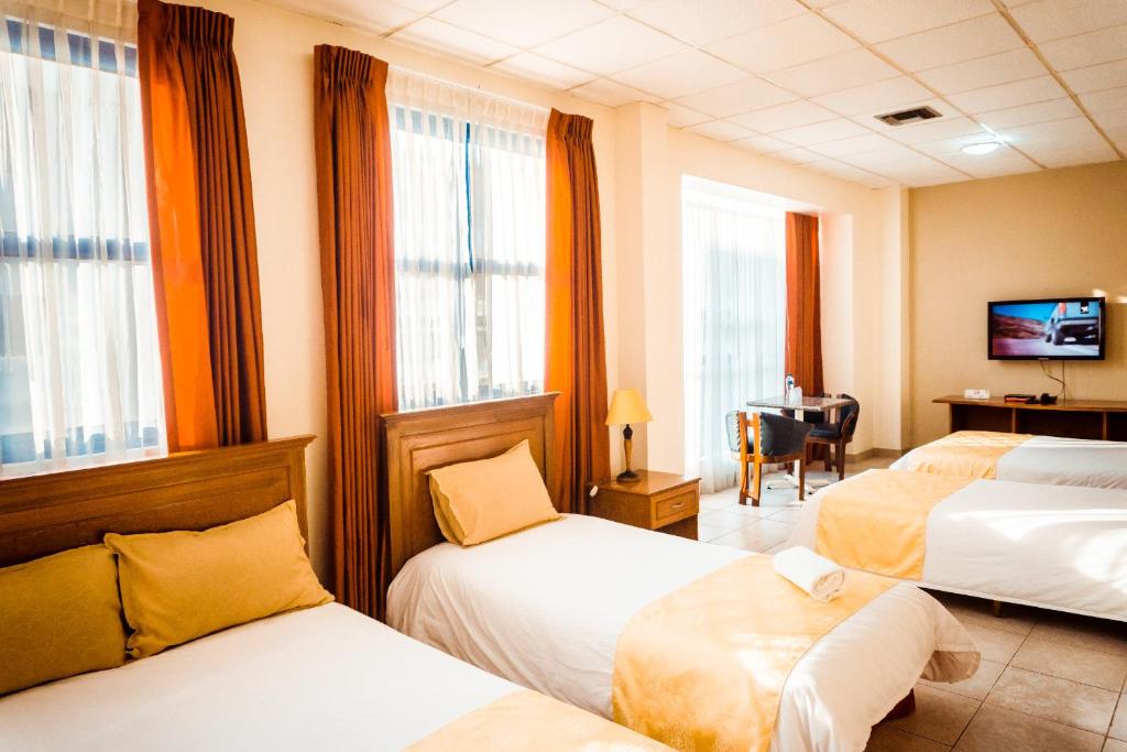 Postel nebo postele na pokoji v ubytování Hotel Las Peñas