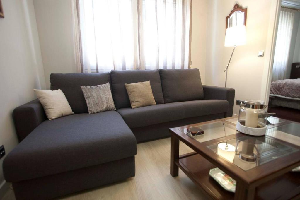 a living room with a couch and a coffee table at Apartamento Maria Inmaculada in Santiago de Compostela