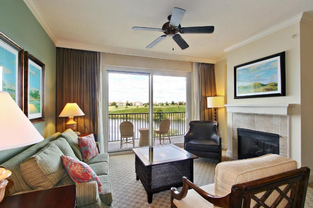 a living room with a couch and a fireplace at Marina Inn at Grande Dunes in Myrtle Beach