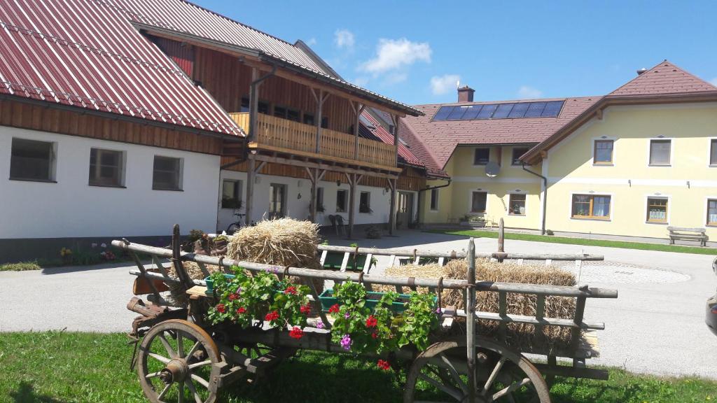 a wooden cart filled with flowers and hay at Ötscherblick Fam Winter in Frankenfels