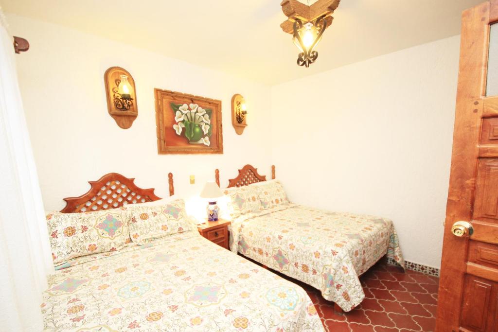 Postel nebo postele na pokoji v ubytování Hotel Mesón del Rosario