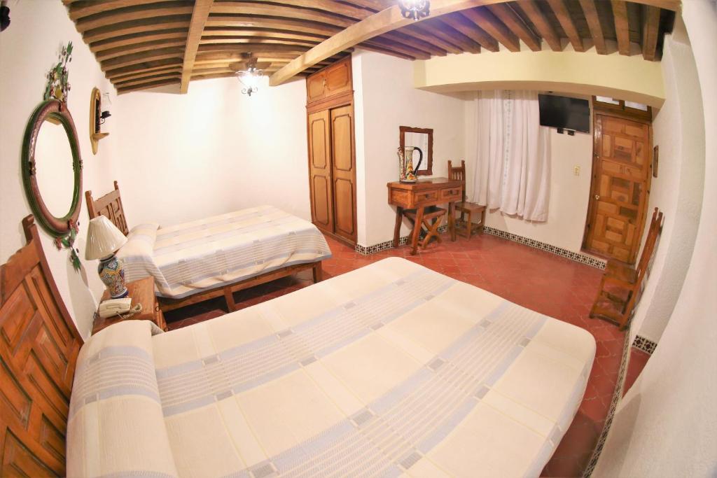 Postel nebo postele na pokoji v ubytování Hotel Mesón del Rosario