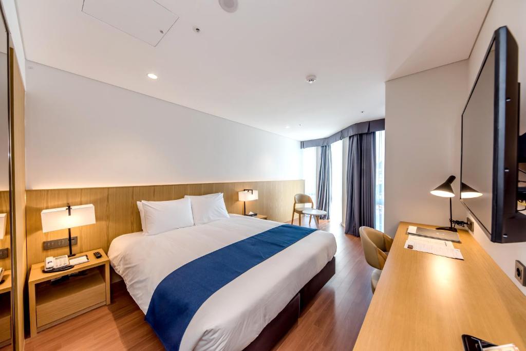 Postel nebo postele na pokoji v ubytování Hotel Sirius