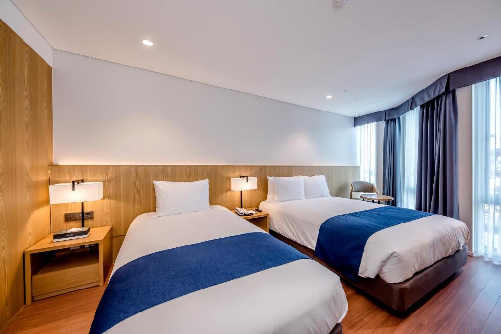 Postel nebo postele na pokoji v ubytování Hotel Sirius