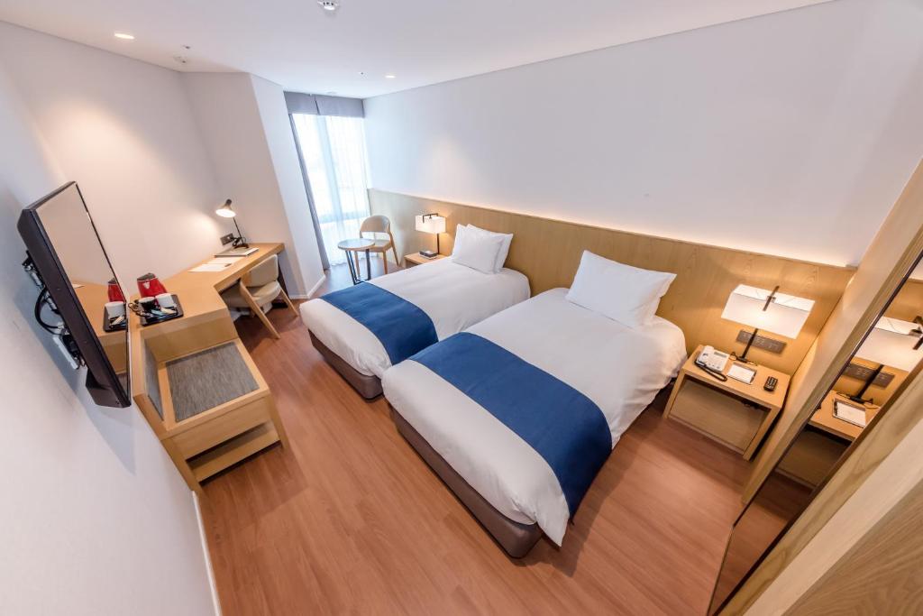 Postel nebo postele na pokoji v ubytování Hotel Sirius