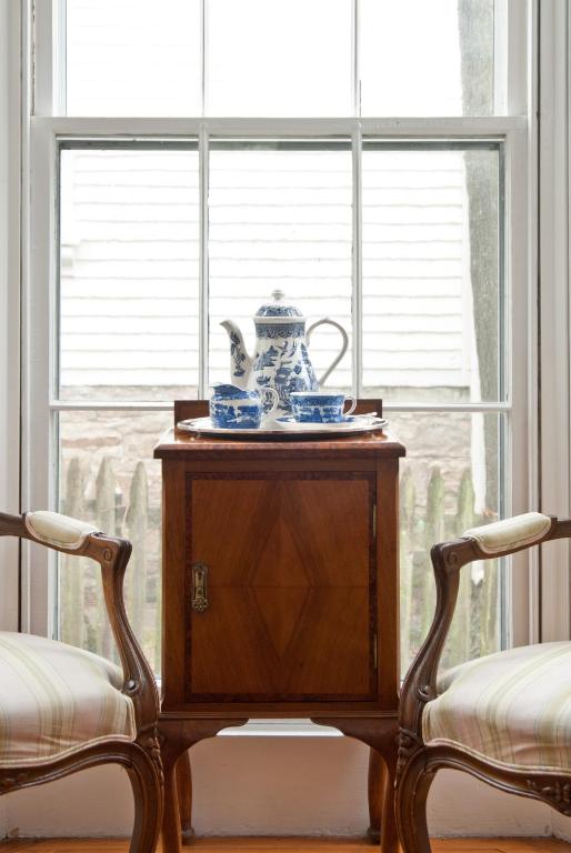 a table with a tea pot on it next to a window at Marshall Slocum Inn in Newport
