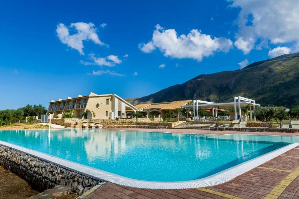 a large swimming pool in front of a building at Borgo Aranci - Appartamento in Villa Orchidea - 12A in Castellammare del Golfo