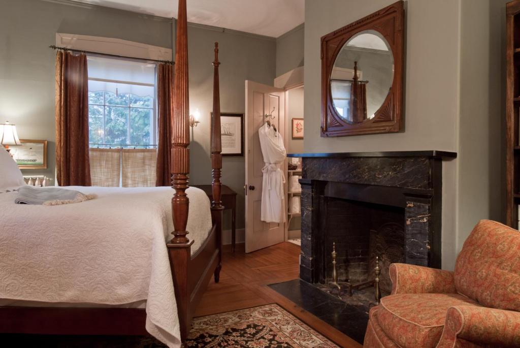 a bedroom with a bed and a fireplace at Marshall Slocum Inn in Newport