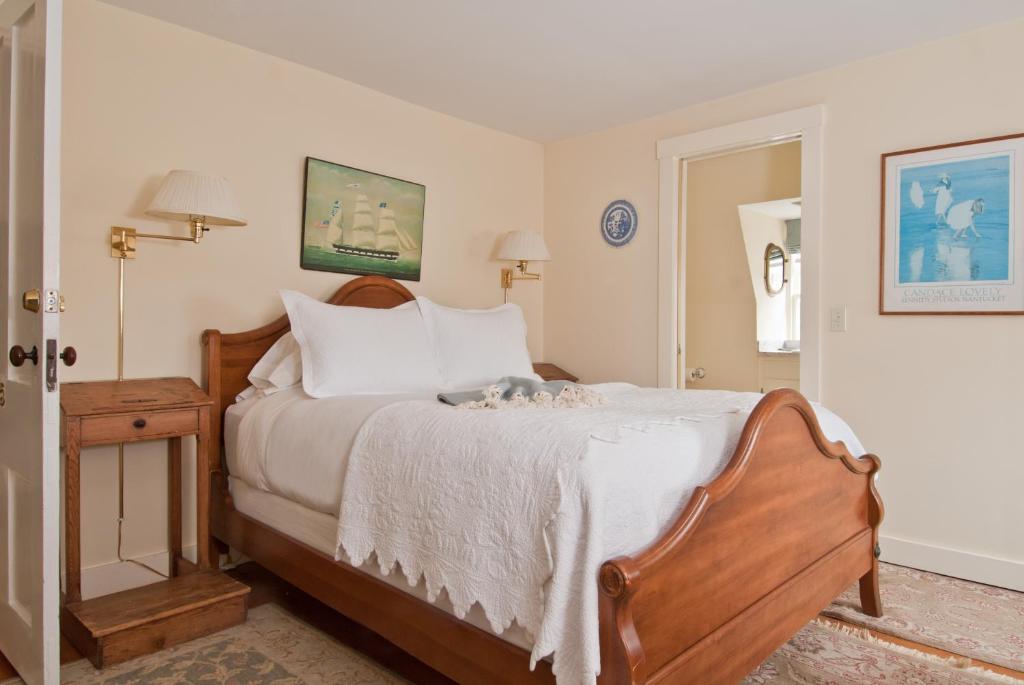 a bedroom with a bed with a wooden head board at Marshall Slocum Inn in Newport