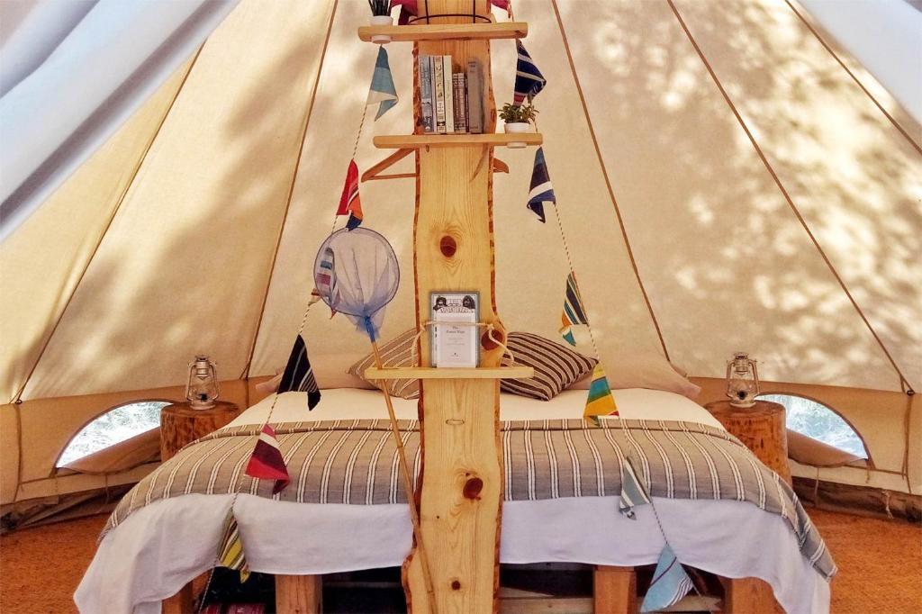 a bed in a teepee with a tent at Forest Days in Navés