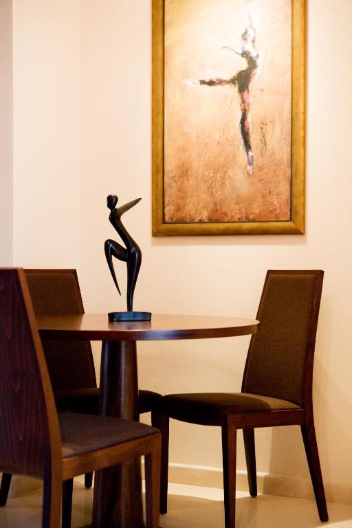 a table with a statue of a woman on it at Melon Suites in Thessaloniki