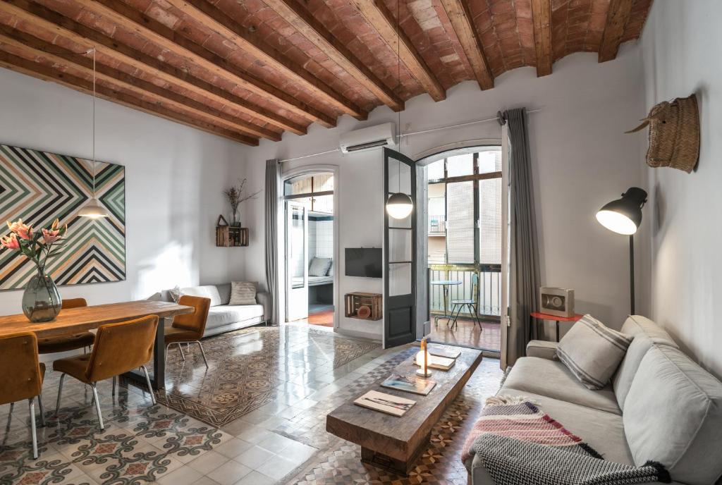a living room with a couch and a table at Brummell Apartments Eixample Derecha/Ballroom in Barcelona