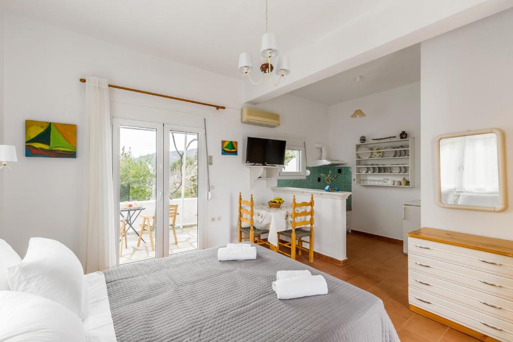 a kitchen and living room with a bed and a table at Villa Thea in Panormos Skopelos