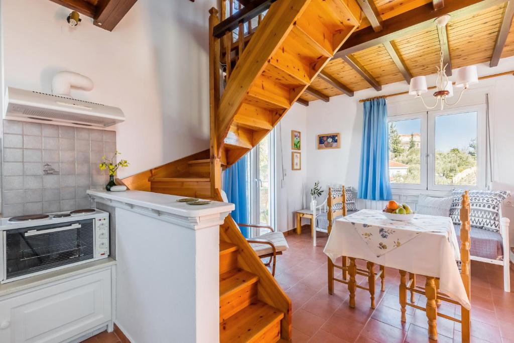 a kitchen with a staircase and a dining room at Villa Thea in Panormos Skopelos