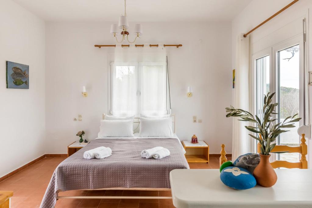 a bedroom with two towels on a bed at Villa Thea in Panormos Skopelos